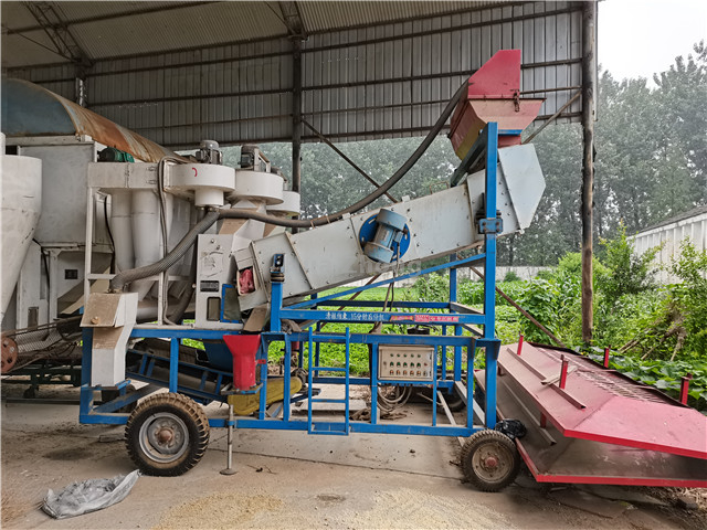 Old type of mobile cleaning vibrating screen in grain warehouse